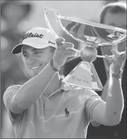  ?? The Associated Press ?? JUSTIN REWARDS: Justin Thomas holds the trophy on Sept. 24, 2017, for winning the FedEx Cup after the Tour Championsh­ip at East Lake Golf Club in Atlanta.