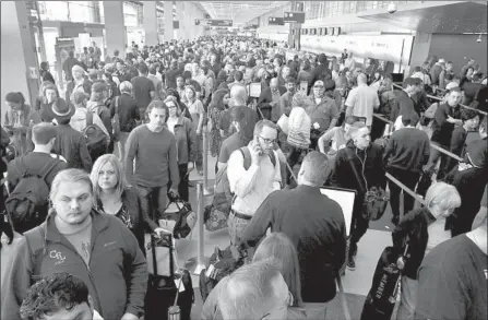  ?? Scott Olson Getty Images ?? MILLIONS of Americans don’t have a document that will be required to fly as of Oct. 1. Above, at Chicago’s O’Hare airport in 2016.