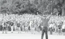  ?? TIM BRADBURY/GETTY IMAGES ?? Tiger Woods celebrates making a par on the 18th green to win the Tour Championsh­ip at East Lake Golf Club for his first victory in five years and coming off back surgery last year.