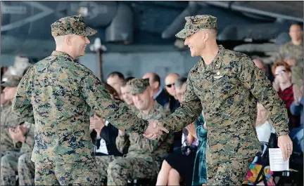  ?? Buy these photos at YumaSun.com PHOTOS BY RANDY HOEFT/YUMA SUN ?? U.S. MARINE CORPS LT. COL. MICHAEL MCKENNEY (LEFT) AND LT. COL. ROBB MCDONALD shake hands during Thursday morning’s change of command ceremony at Marine Corps Air Station Yuma, during which McDonald assumed command of Marine Attack Squadron 311 (VMA-311), the Tomcats, from McKenney. McKenney had just concluded his remarks and was followed by McDonald.