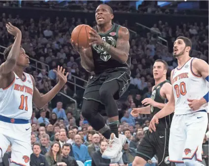  ?? ASSOCIATED PRESS ?? Milwaukee Bucks guard Eric Bledsoe (6) goes to the basket past New York Knicks guard Frank Ntilikina (11) and center Enes Kanter (00) during the first half.