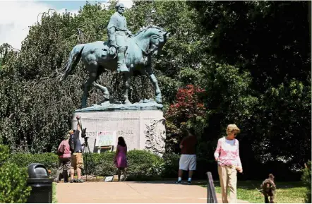  ??  ?? Controvers­ial figure: The statue of Confederat­e General Robert E. Lee sitting at the centre of the park formerly dedicated to him, the site of recent violent demonstrat­ions in Charlottes­ville, Virginia. — Reuters