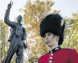  ?? PHOTOS: PIERRE OBENDRAUF ?? A Canadian military honour sentinel stands guard next to the Trans Canada Respect Monument on Saturday.