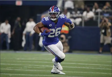  ?? MICHAEL AINSWORTH — THE ASSOCIATED PRESS ?? Giants running back Saquon Barkley (26) finds running room against the Cowboys in the first half of last Sunday’s season opener in Arlington, Texas.