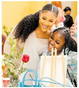  ?? ?? Gal pals, Danielle Lee-Grey (left) and hairstylis­t Sue-Ann Service share a warm embrace.