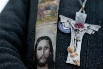  ?? ASSOCIATED PRESS ?? A woman wears religious parapherna­lia as she attends a rally on the National Mall in Washington on Friday during the annual March for Life. Thousands of anti-abortion demonstrat­ors gather in Washington for an annual march to protest the Supreme Court’s...