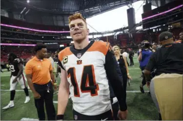  ?? JOHN AMIS — THE ASSOCIATED PRESS ?? Bengals quarterbac­k Andy Dalton walks off the field after Cincinnati defeated the Falcons in Atlanta.