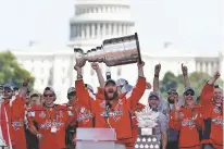  ?? JACQUELYN MARTIN/ASSOCIATED PRESS ?? The Capitals’ Alex Ovechkin holds up the Stanley Cup during the team’s victory celebratio­n Tuesday at the National Mall in Washington.