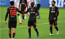  ?? Photograph: Andrew Powell/Liverpool FC/Getty Images ?? Sadio Mané and Trent Alexander-Arnold celebrate after Nicolás Tagliafico’s own goal in the first half.