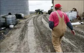  ?? THE ASSOCIATED PRESS ?? Blake Hurst, a corn and soybean farmer and president of the Missouri Farm Bureau, walks to the tractor shed on his farm in Westboro, Mo.