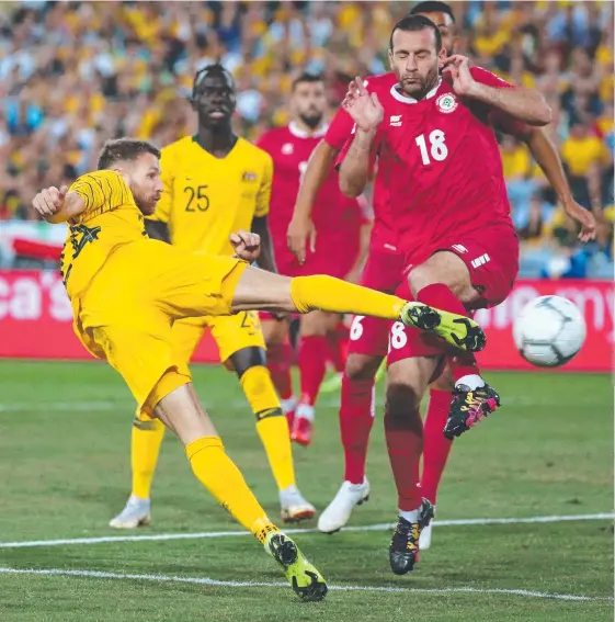  ?? Picture: AFP ?? Scottish-born Socceroos winger Martin Boyle (left) attempts a shot on goal as Lebanon’s Walid Ismail tries to block it.