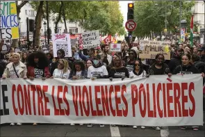  ?? (AP/Michel Euler) ?? People march with a banner Saturday that reads, “against police violences,” in Paris.