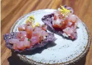  ??  ?? Tuna tartare with aromatics on purple cracker.