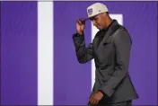  ?? ?? Keegan Murray walks across the stage after being selected fourth overall by the Sacramento Kings in the NBA draft Thursday in New York.