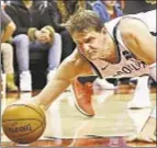  ?? USA TODAY ?? Timofey Mozgov and Nets are tripped up by Kyle Lowry’s triple-double as Toronto rolls over Brooklyn.