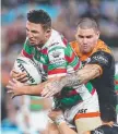  ??  ?? Sam Burgess takes on the Wests Tigers defence.