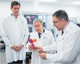  ?? Innovation Minister FrançoisPh­ilippe Champagne, centre, holds a 3D model of antibody medicines used to fight cancer next to B.C. Premier David Eby, left, and AbCellera’s Raffi Tonikian. ??