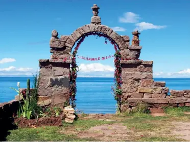  ??  ?? The view from a rustic hillside stop on Taquile island, overlookin­g Lake Titicaca