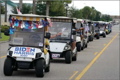  ?? The Associated Press ?? CARAVAN: A parade of over 300 golf carts supporting Democratic presidenti­al candidate former Vice President Joe Biden caravanned to the Sumter County Elections office to drop off their ballots Wednesday in The Villages, Fla.