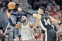  ?? [TONY DEJAK/THE ASSOCIATED PRESS] ?? Cleveland’s LeBron James reaches for a pass as San Antonio’s Danny Green defends during Sunday’s game.