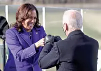  ?? (Jonathan Ernst/Pool Photo via AP) ?? Vice President Kamala Harris bumps fists with Presidente­lect Joe Biden after she was sworn in Wednesday at the U.S. Capitol in Washington.