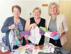  ?? 280715UNIF­ORM_01 ?? Clothing call Sandra Laird (right) with Emily Bryce and Christine Campbell are seeking help