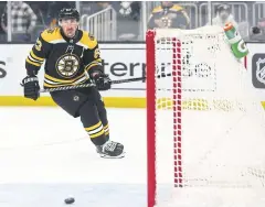  ?? AFP ?? The Bruins’ Brad Marchand scores against the Hurricanes.