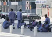 ?? Pawan Singh / The National ?? Labourers waiting for their staff bus after the midday break at one of the constructi­on site in Al Garhoud area of Dubai