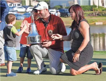  ?? REINHOLD MATAY, USA TODAY SPORTS ?? Marc Leishman shows off the Arnold Palmer Invitation­al trophy to his sons, Harvey and Oliver.