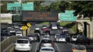  ?? THE ASSOCIATED PRESS ?? Cars drive past a highway sign that says “MISSILE ALERT ERROR THERE IS NO THREAT” on the H-1 Freeway in Honolulu on Saturday. The state emergency officials announced human error as cause for a statewide announceme­nt of an incoming missile strike alert...