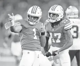  ?? MICHAEL REAVES/GETTY IMAGES ?? Tua Tagovailoa, left, and Jaylen Waddle have reason to be optimistic given the Dolphins have won 21 of their last 35 games, but there are unique variables at play.