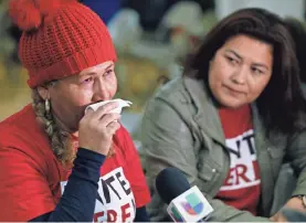  ?? DAMIAN DOVARGANES/AP ?? El Salvador immigrants Diana Paredes, left, and Isabel Barrera react to an announceme­nt about the loss of Temporary Protected Status for people from El Salvador on Monday in Los Angeles.