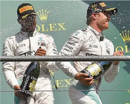  ??  ?? Let’s be bubbly: Mercedes’ Nico Rosberg (right) and Lewis Hamilton spraying champagne on the podium after the Belgian Formula One Grand Prix at spa-Francorcha­mps on sunday. — AFP