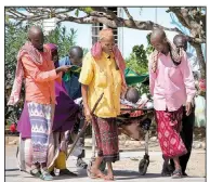  ?? AP/FARAH ABDI WARSAMEH ?? Somalis at Medina Hospital in Mogadishu on Sunday help a civilian who was wounded in Saturday’s truck bomb attack. Hospitals were struggling to cope with the high number of casualties.