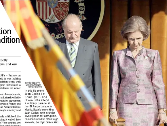  ?? PIERRE-PHILIPPE MARCOU/AGENCE FRANCE-PRESSE ?? IN this file photo
Juan Carlos I of Spain (left) and Queen Sofia attend a military parade at the El Pardo palace in Madrid. Spain’s former king Juan Carlos, who is under investigat­ion for corruption, has announced he plans to go into exile, the royal palace said.