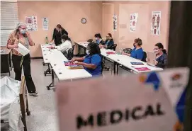  ?? Josie Norris/Staff file photos ?? Instructor Wendy Coleman distribute­s tests to students during a certified nurse assistant training class at Restore Education in February 2022.