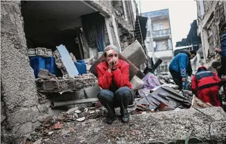  ?? Bulent Kilic / Tribune News Service ?? An survivor reacts as rescuers look for victims and other survivors in Hatay, Turkey, on Tuesday, the day after an earthquake struck the country’s southeast.