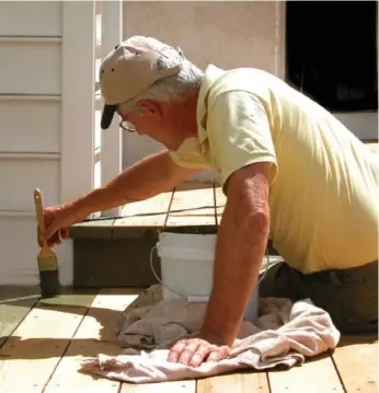  ?? DREAMSTIME ?? A solid stain is an option to make your wooden deck look better if power-washing and scrubbing don’t work. A stain will need annual maintenanc­e, though.