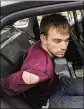  ?? METROPOLIT­AN NASHVILLE POLICE DEPARTMENT ?? Travis Reinking sits in a police car after being arrested in Nashville, Tenn., on Monday. Police said Reinking opened fire at a Waffle House early Sunday, killing at least four people and wounding several more.