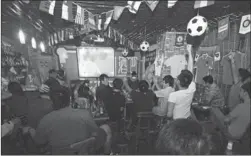  ?? PROVIDED TO CHINA DAILY ?? Soccer fans watch a World Cup match in a bar in June. China is looking to open the sports broadcasti­ng market to expand the fan base and benefit more audiences.