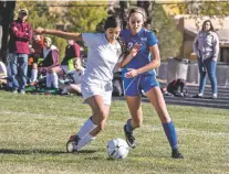  ?? JANE PHILLIPS/FOR THE NEW MEXICAN ?? Academy for Technology and the Classics’ Jennifer Guerra, left, and St. Michael’s Claire Patten fight for the ball Saturday at Christian Brothers Athletic Complex in the Girls State Soccer Tournament. St. Michael’s won 9-1.