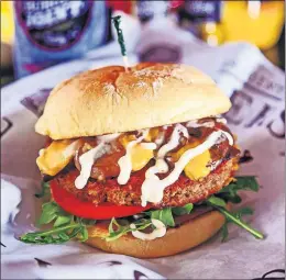  ?? [CHRIS LANDSBERGE­R PHOTOS\THE OKLAHOMAN] ?? A Mushroom Burger from S&amp;B Burger Joint with a plant-based Impossible patty.
