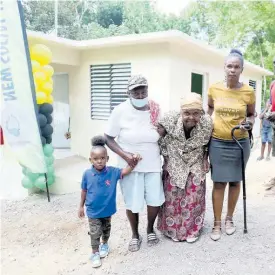  ?? NATHANIEL STEWART ?? Woodhall, Clarendon senior Lillian Wynter poses with family members infront of her newly constructe­d house.