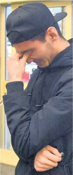  ??  ?? > Mohammed Mirzo is overcome with emotion after being reunited with his family at Cardiff Central station yesterday