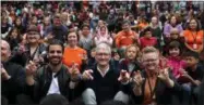  ?? JUSTIN SULLIVAN — GETTY IMAGES ?? Apple CEO Tim Cook, center, and actor, model, and activist for the deaf community Nyle DiMarco, left, gesture while taking a picture with students at the California School for the Deaf on May 17in Fremont, California. Cook and DiMarco visited students...