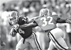  ?? Associated Press ?? ■ Georgia running back Prather Hudson (24) tries to breaks free from Monty Rice (32) during the first half of the G-Day inter-squad spring football game Saturday in Athens, Ga.