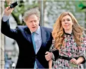  ?? — AFP ?? Britains Prime Minister Boris Johnson and partner Carrie Symonds arrive at Methodist Hall in central London to cast their votes in local elections.