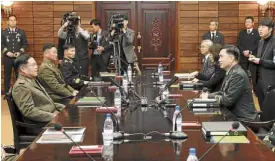  ?? —AP ?? BORDER PACT North Korean Lt. Gen. An Ik-san (left) meets with South Korean Maj. Gen. Kim Do-gyun on how to dismantle guard posts on their border.