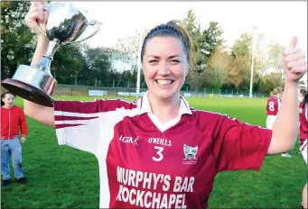  ??  ?? A jubilant St Peter’s captain Mairín Stack celebrates after winning the County Championsh­ip against Bantry Blues and, right, celebratio­ns on the pitch after the presentati­on Photo by John Tarrant