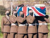  ?? JOE GIDDENS/POOL ?? The coffin of Captain Tom Moore is carried by Armed Forces members Saturday in Bedford, England.